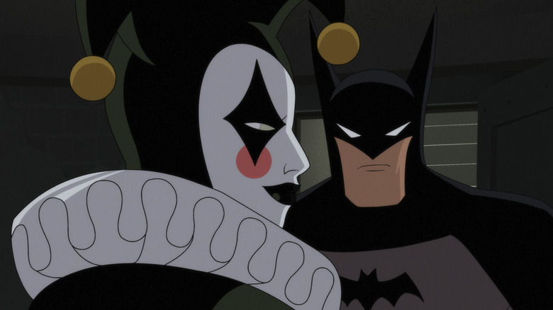 Harley Quinn looking over her shoulder stood next to Batman in Batman: Caped Crusader