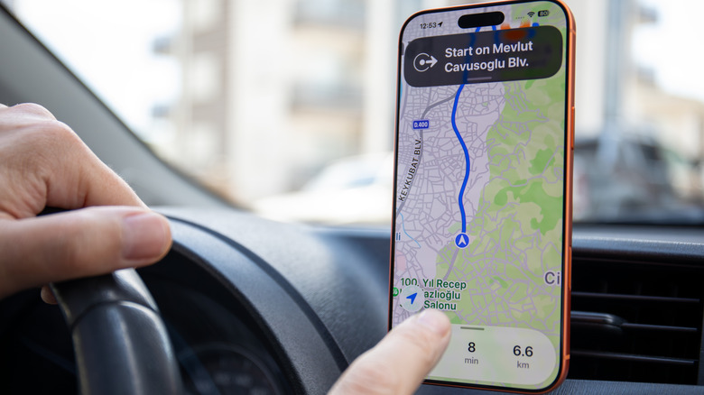 A person using the iPhone 17 Pro to navigate with Apple Maps.