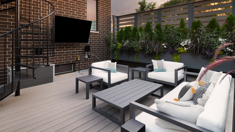 An outdoor TV on a patio with furniture