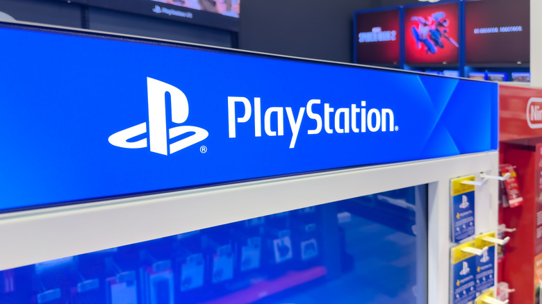 blue playstation sign with logo on a store display.