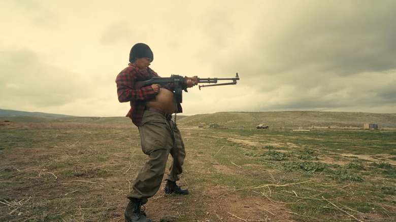 Perfidia Beverly Hills, played by Teyana Taylor, shoots a machine gun while pregnant in one of One Battle After Another's most iconic scenes.