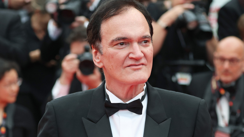 Quentin Tarantino at a premiere in a black suit