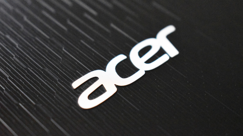 Close up shot of the Acer logo on a black laptop