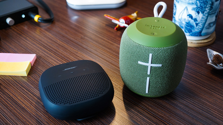 Bose and Ultimate Ears portable Bluetooth speakers on a table