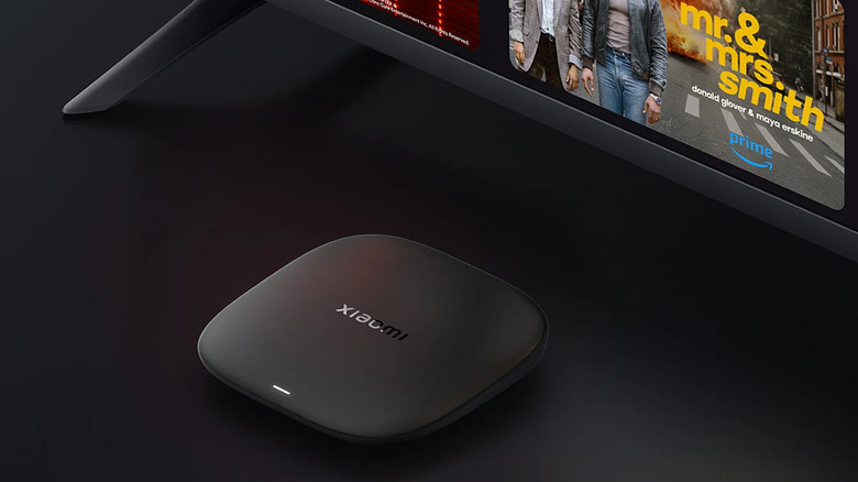 Xiaomi TV Box under a TV on black background