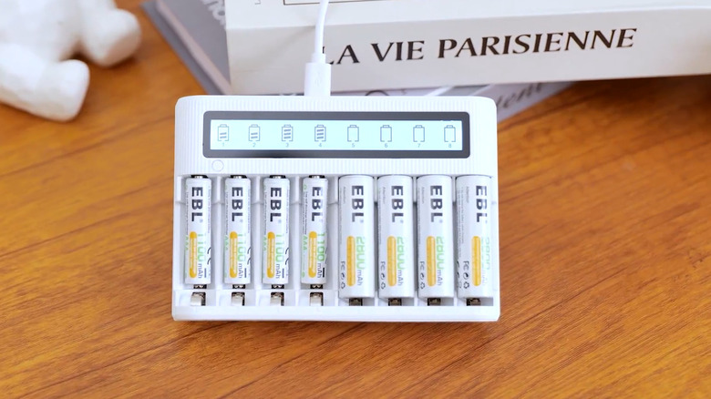 EBL Batteries being charged on a desk on top of books