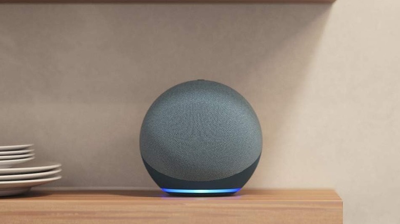 The Amazon Echo (4th Gen) smart speaker on a wooden shelf.