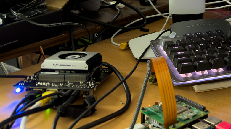 A messy desk with Mu Ultra and Pi 5