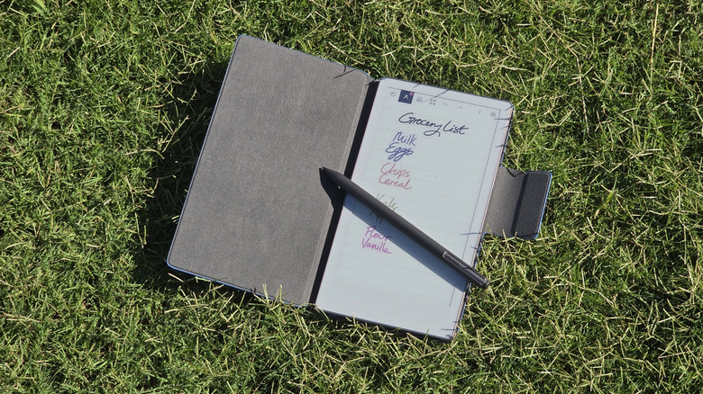 remarkable paper pro move open on grass with folio case, showing grocery list