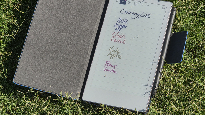 remarkable paper pro move open on grass with folio case, showing grocery list