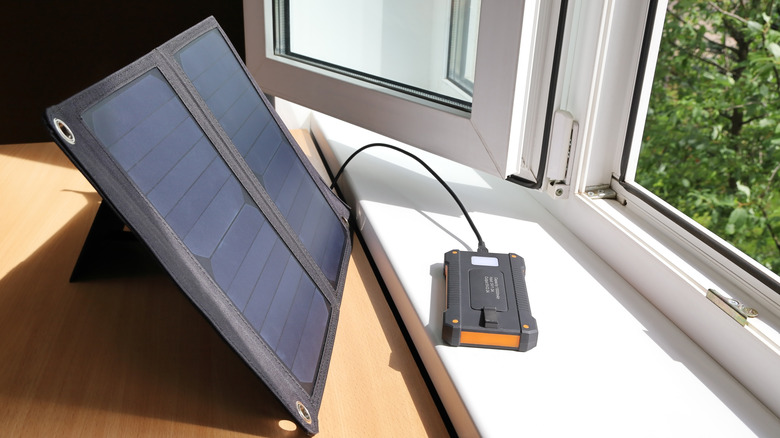 a solar powered portable charger on a windowsill