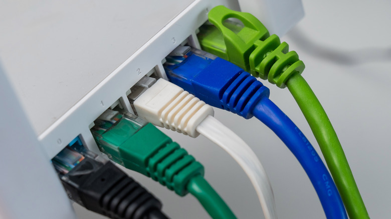 Several ethernet cables plugged into ports.