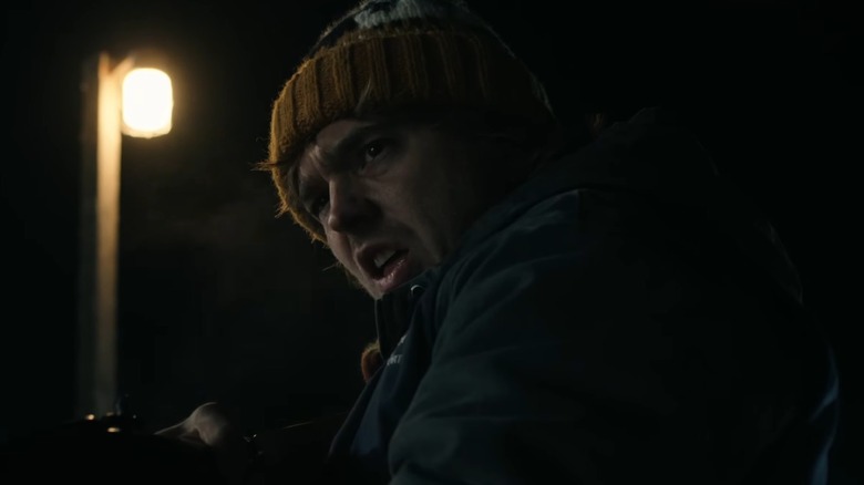 Austin Abrams holding a rifle in 'Resident Evil'