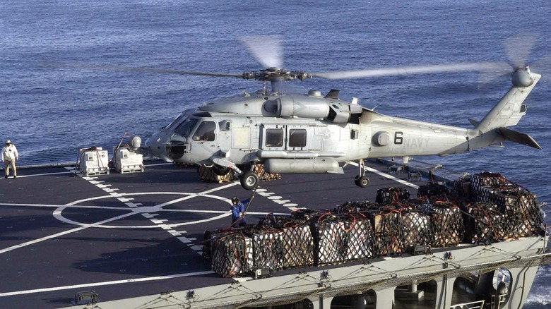 MH-60S Seahawk helicopter delivering supplies to an aircraft carrier