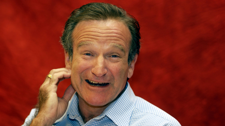 Robin Williams with a red background