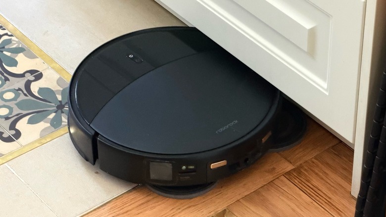 Close-up shot of a robot vacuum using its mop capabilities on a kitchen floor
