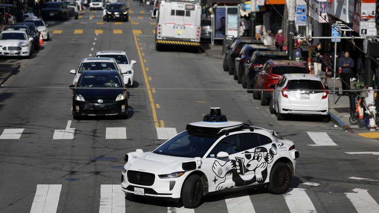 A Waymo driverless robotaxi turning in an intersection