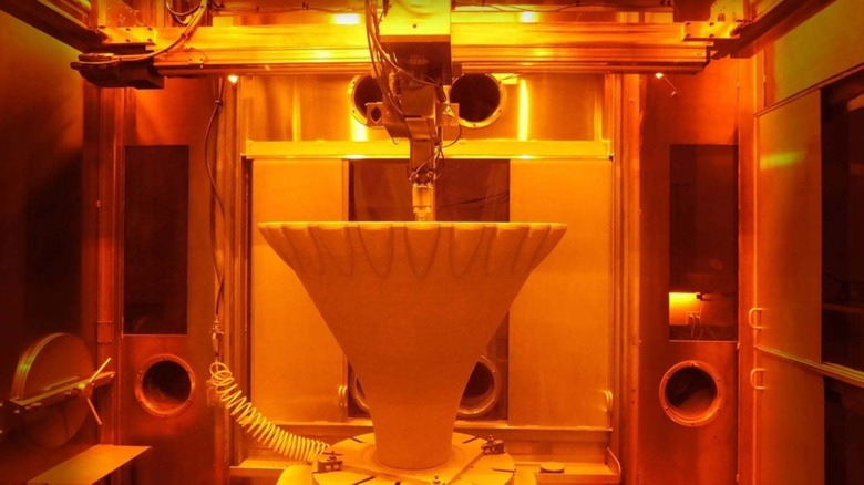 3D printer manufacturing metal rocket engine part for NASA