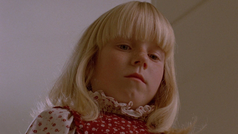 Candice (Cindy Hinds) looking down at something in "The Brood."
