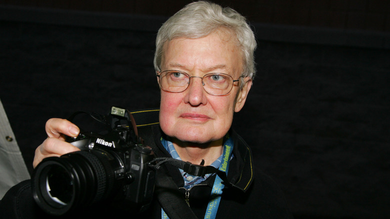 Roger Ebert holding a camera