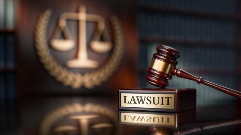 Close-up of a judge's gavel resting on a block labeled 