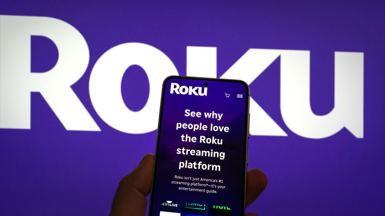 Roku app on a smartphone with its logo behind