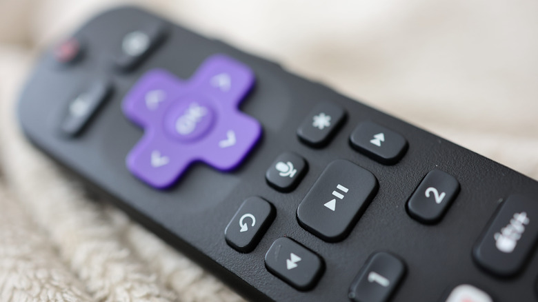 A close-up photograph of a Roku TV remote.