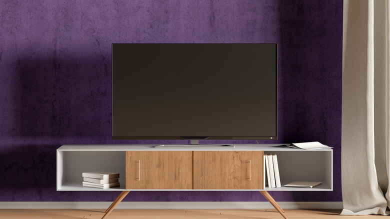 A smart TV sitting on a media console in a living room.