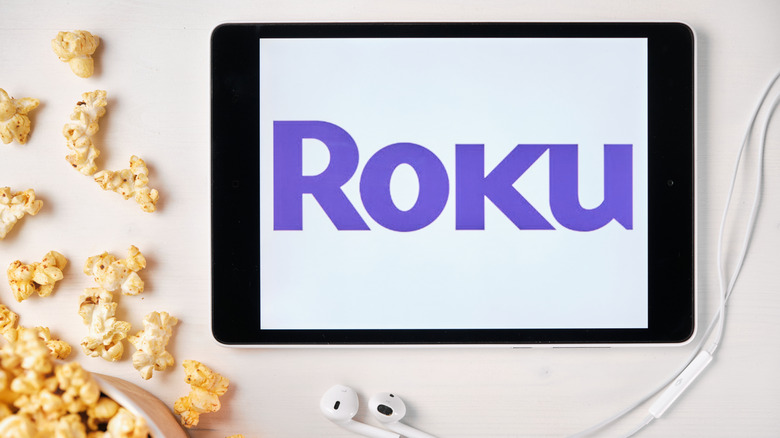 A tablet displaying the Roku logo next to popcorn
