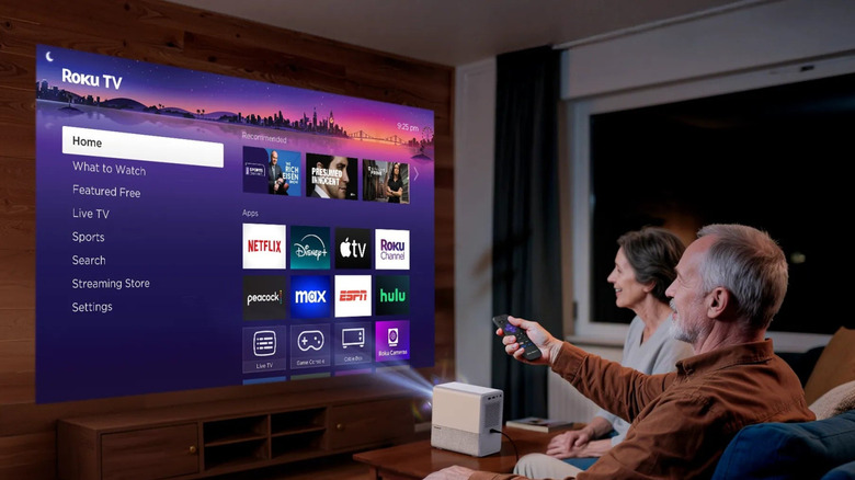 An older couple using the Aurzen Roku TV Smart Projector D1R Cube.