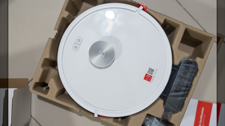 The Roborock Q7 vacuum in its shipping box sitting on a table