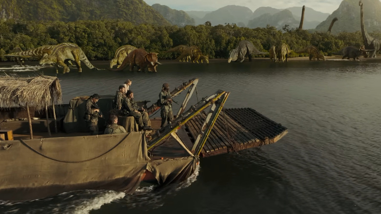 Vulture recon unit on a boat passing dinosaurs in the water