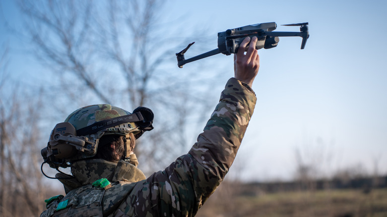 A soldier shown holding a drone pre-deployment