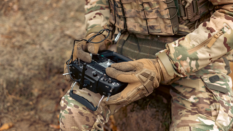 a soldier remotely controlling a drone