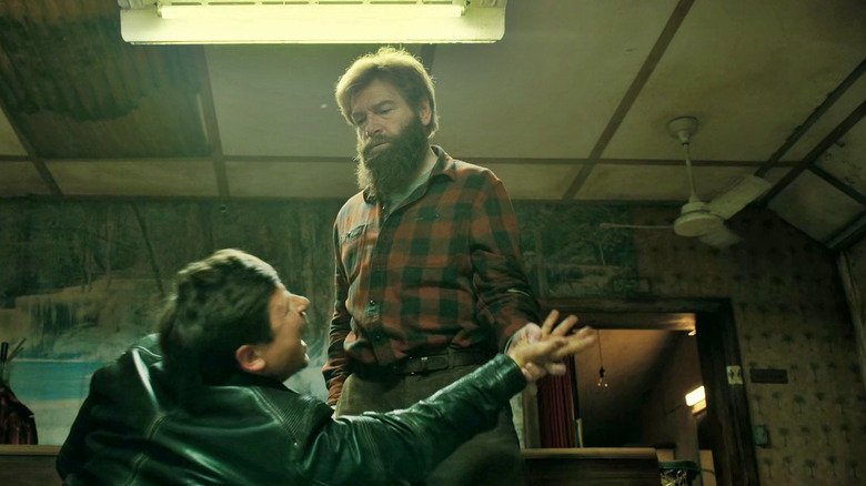 Nik twisting the arm of a local Russian in a bar