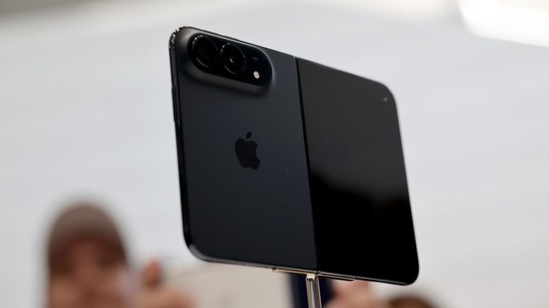A black iPhone Duo on a stand at an event.