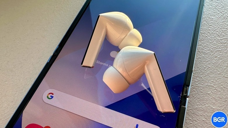 The Samsung Galaxy Buds 3 Pro on top of a smartphone screen