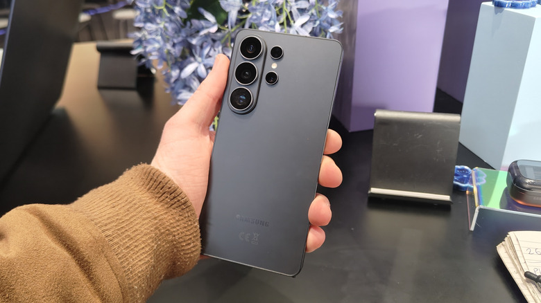 The rear of a Samsung Galaxy S26 Ultra, held in a man's hand