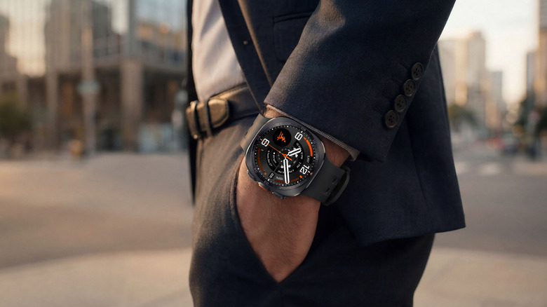 A man in a suit wears a Galaxy Watch Ultra 2 with his hand in his pocket