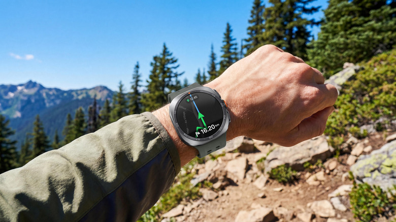 A hiker wears a Galaxy Watch Ultra 2 on a mountainside