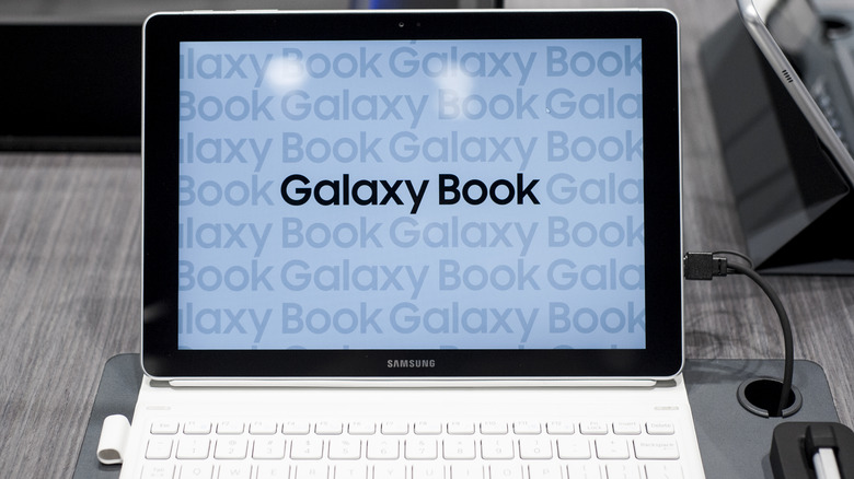an opened Galaxy Book showing the Galaxy Book text on screen