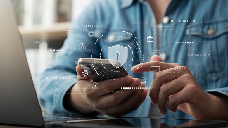 person using smartphone with security concept hovering in front of it