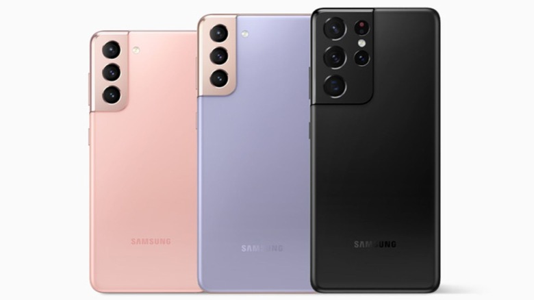 Samsung Galaxy S21 series smartphones in peach, lavender, and black colors.