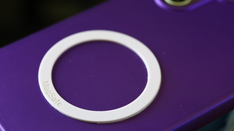 MagSafe magnet attached to the back of someone's smartphone
