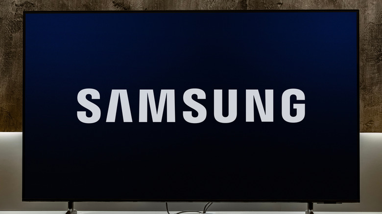 A Samsung TV showing the Samsung logo on screen.