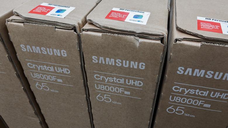 Samsung TVs in a row in boxes.