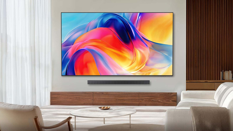 The Samsung M70H Mini-LED TV mounted on a wall with a colorful image onscreen