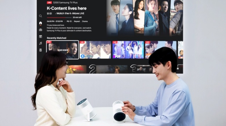 Two Samsung Freestyle Plus projectors on a table.