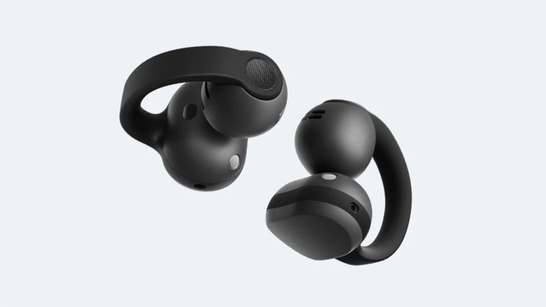 Two black Galaxy Buds On earbuds sitting against a light blue background