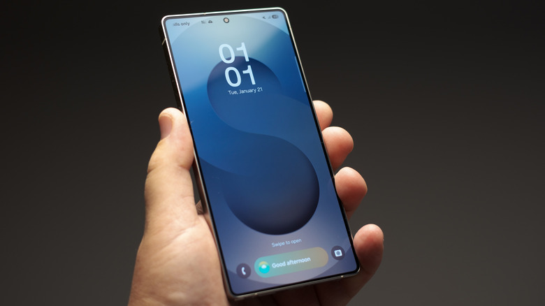hand holding a samsung galaxy s25 ultra smartphone with lock screen visible